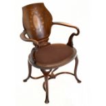 An Edwardian inlaid mahogany elbow chair on cabriole supports.