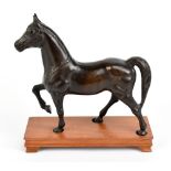 A 20th century cast bronze sculpture representing a prancing horse, on teak stand, length 20cm.