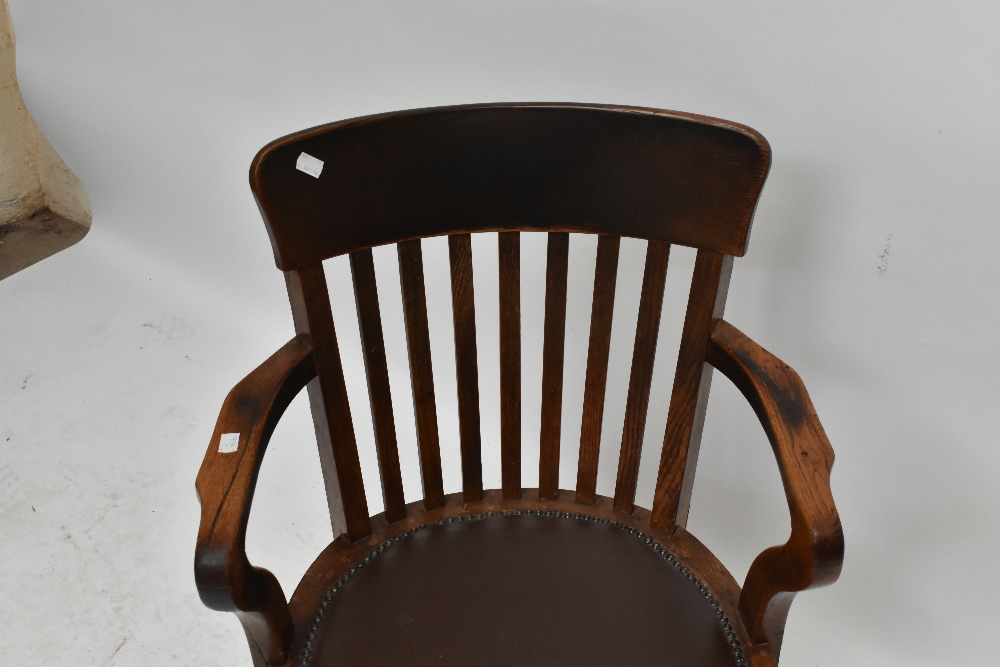 An early 20th century oak revolving desk chair. - Image 2 of 5