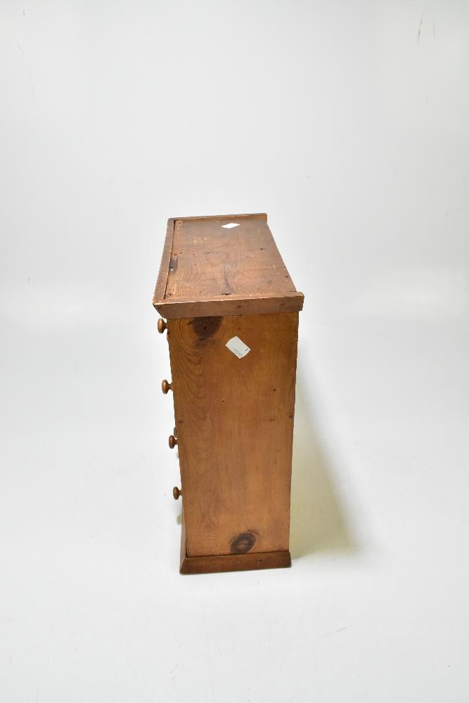 A pine miniature chest of eight drawers, raised on plinth base, width 33.5cm, height 40.5cm, depth - Bild 6 aus 6