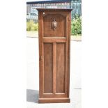 THE VERITHING; a 1950s oak hall robe, the single panelled door with carved detail to the top