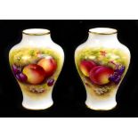 EDWARD TOWNSEND FOR ROYAL WORCESTER; a pair of hand painted vases each decorated with fruit,