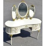A French-style cream painted kidney shaped dressing table, with oval triptych mirror back above five