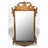 A 20th century Georgian style walnut framed fretwork wall mirror, 67 x 36cm.Additional