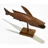 A Pitcairn Island carved wood flying fish, one wing stamped 'Made by Wallace Warren', the other