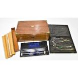A walnut and brass bound writing slope, 13 x 35.5 x 22cm, two cased sets of drawing instruments