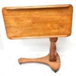 A Victorian mahogany adjustable reading table, with turned column on shaped base, height when closed