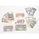 A collection of thirty five pre-decimal bank notes comprising a Peppiatt purple ten shilling note,