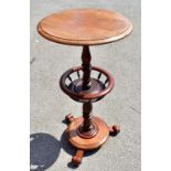 An early 19th century mahogany sewing table with circular top raised on a single column with a