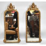 A pair of late 19th century gilt console mirrors with pierced floral finials, height 93cm, width