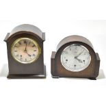 An Edwardian mahogany mantel clock, the silvered dial with Roman numerals, raised on four brass