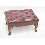 A red leather button top rectangular footstool, on cabriole legs, height 31cm, length 60cm, depth