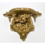 A Louis XV style carved gilt wood and gesso wall bracket, modelled with elaborate acanthus scrolls