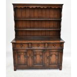 TITCHMARSH & GOODWIN; an oak dresser, the boarded plate rack with carved apron above two shelves,