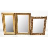 A pierced and carved gilt wood and gesso rectangular wall mirror, the frame detailed with scrolls,