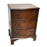 A reproduction mahogany serpentine fronted three drawer chest, raised on bracket feet, width 51cm,