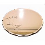 An Art Deco style peach glass mirror with etched palm tree decoration and bevelled edge, diameter