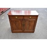 A 19th century mahogany side cabinet with two drawers and two panelled cupboard doors flanked by