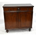 A late 19th century oak side cabinet with a long drawer to the top above two panelled doors