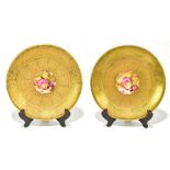 H.HENRY FOR ROYAL WORCESTER; two hand painted gilt decorated cabinet plates of circular form, with