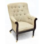 A Georgian style mahogany framed armchair upholstered in a striped button back material raised on