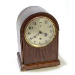 An Edwardian oak domed mantel clock, the circular dial set with Arabic numerals and manufacturer's