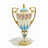 MINTONS; a twin handled hand painted pedestal lidded vase, decorated with roses inside gilt and