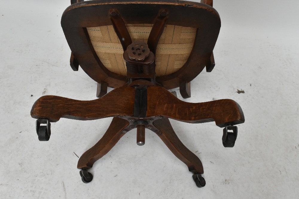 An early 20th century oak revolving desk chair. - Image 4 of 5