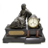 A late 19th century bronzed spelter and marble figural mantel clock modelled as a maiden seated