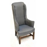 A reproduction Georgian style high back elbow chair, upholstered in a blue floral material, raised