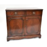 A reproduction mahogany sideboard, with two drawers above two panelled cupboard doors raised on