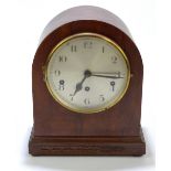 An Edwardian inlaid mahogany dome topped mantel clock, the silvered dial with Arabic numerals,