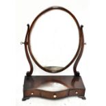 ***WITHDRAWN***A reproduction mahogany dressing table mirror, the oval mirror above serpentine