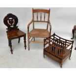 A mid-Victorian mahogany hall chair with carved back on turned front supports, a rush seated