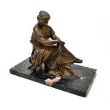 An early 20th century bronzed spelter figure group depicting a seated maiden wearing a flowing