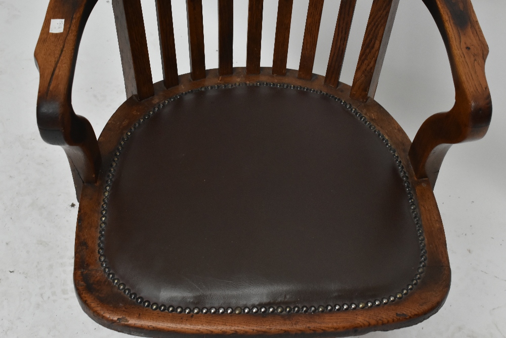 An early 20th century oak revolving desk chair. - Image 3 of 5