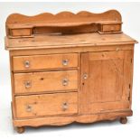 A Victorian pine dresser base, the raised back with two short drawers above three short drawers