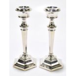 SANDERS & MACKENZIE;  a pair of Elizabeth II hallmarked silver candlesticks of tapered form on