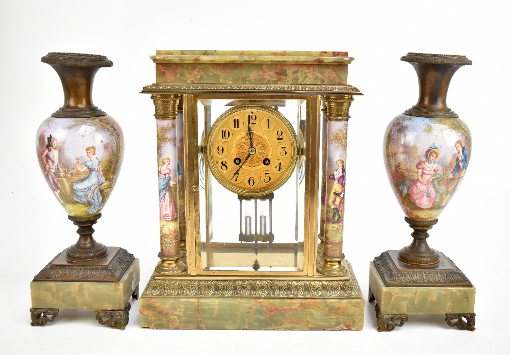 MARTI ET CIE; a late 19th century French onyx, gilt metal and porcelain mantel clock garniture,