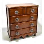 A 19th century mahogany miniature chest of two short over three long drawers, with moulded glass