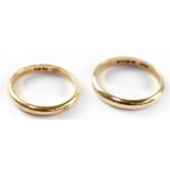 An 18ct gold plain band, size J, approx 2.3g and a 9ct gold band, size M, approx 2g (2).