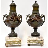 A pair of 20th century bronzed metal urns in a Classical manner, with swags and garland handles,