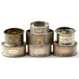 Seven hallmarked silver napkin rings to include a pair of oval napkin rings,