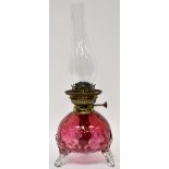 A 19th century cranberry glass oil lamp,