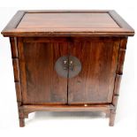 A modern large stained wood Chinese-style cabinet, with faux bamboo columns,