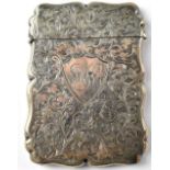 A Victorian hallmarked silver card case with scroll and foliate chased decoration,