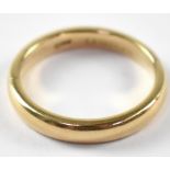 An 18ct gold band ring, size J, approx. 3.7g.