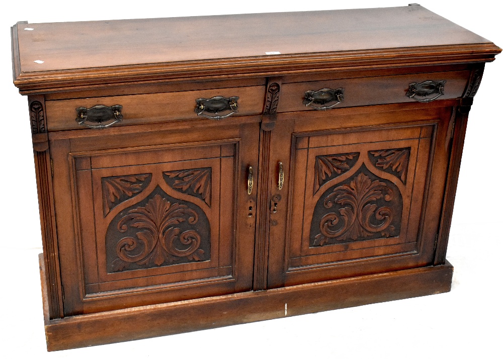 A Victorian mahogany sideboard, two curved drawers over two carved panel doors, to plinth base,