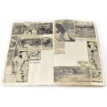 A WWII scrap book with handwritten notes and newspaper cuttings to include extracts, maps, pictures,