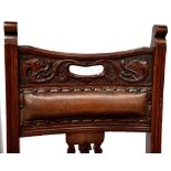 A pair of late 19th/early 20th century mahogany carvers, splat backs to outswept arms,